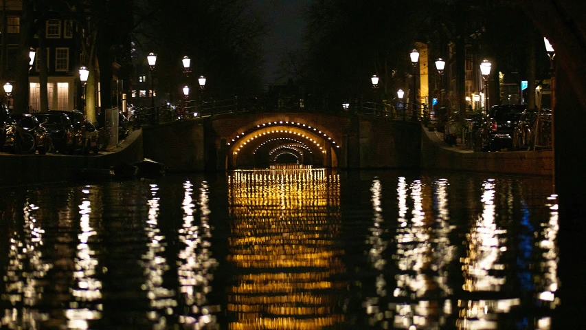 a view of an under lit bridge in the night