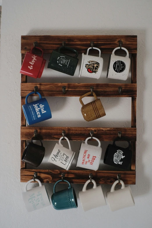 two wood racks hold different coffee cups in front of the wall