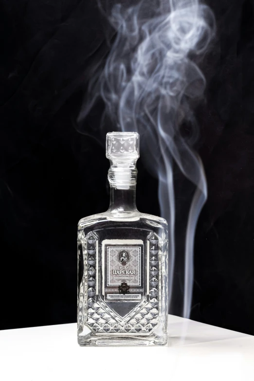 smoke billowing out from a bottle of liquor