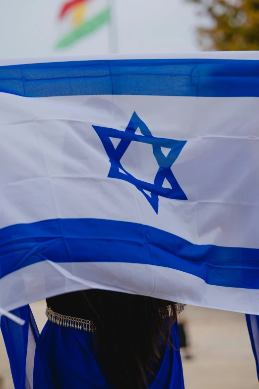 a woman wearing a scarf with an israeli flag