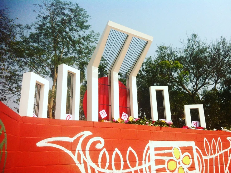 a large red wall with paintings on it