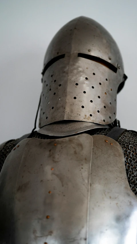 armor worn by a soldier wearing silver, with holes in the chest