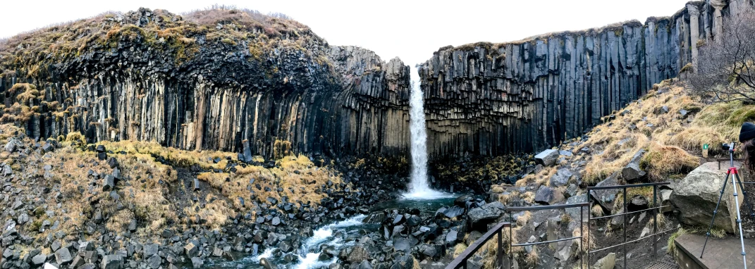 a large waterfall coming down a mountain side