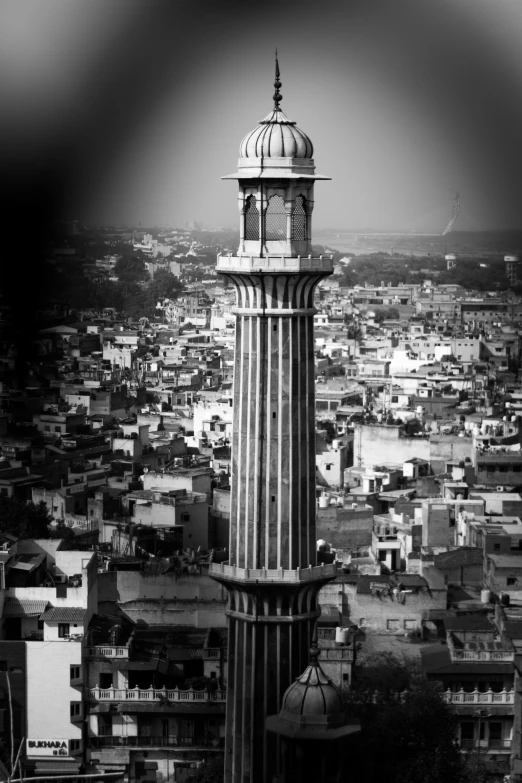 a tall tower sitting over a city in the middle of a city