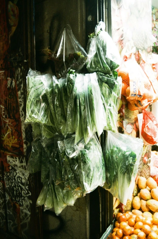 a large pile of vegetables and fruit outside a building