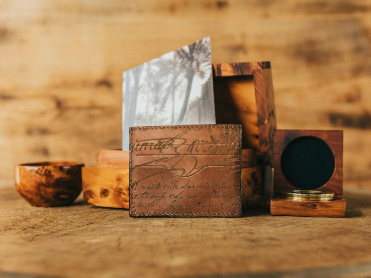 a wooden box containing an empty notepad and small box