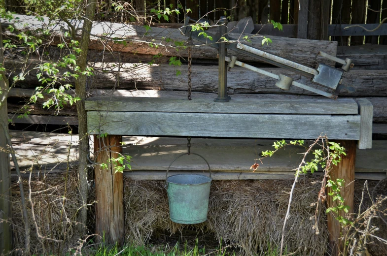 an empty bucket and bucket is next to a fence