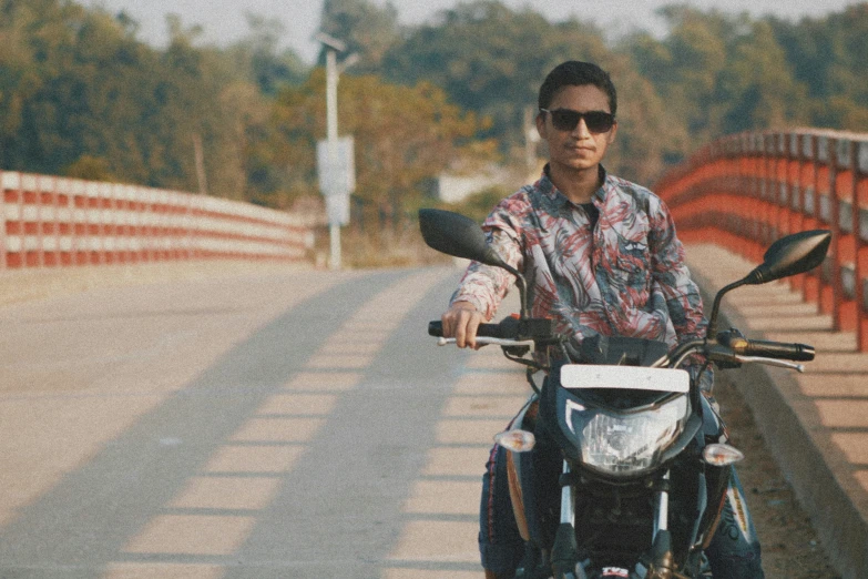 a man riding a motorcycle with glasses on it