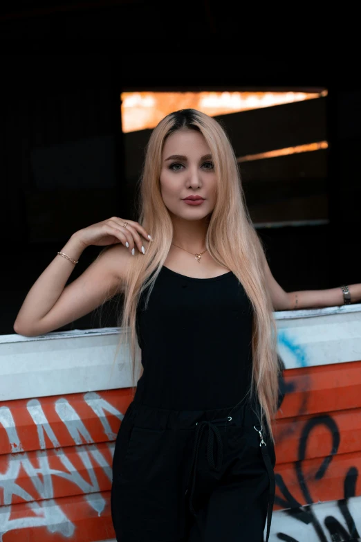 an image of a woman posing by a wall