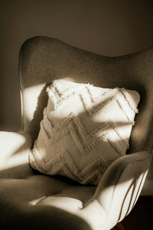 a large white pillow sitting on top of a chair