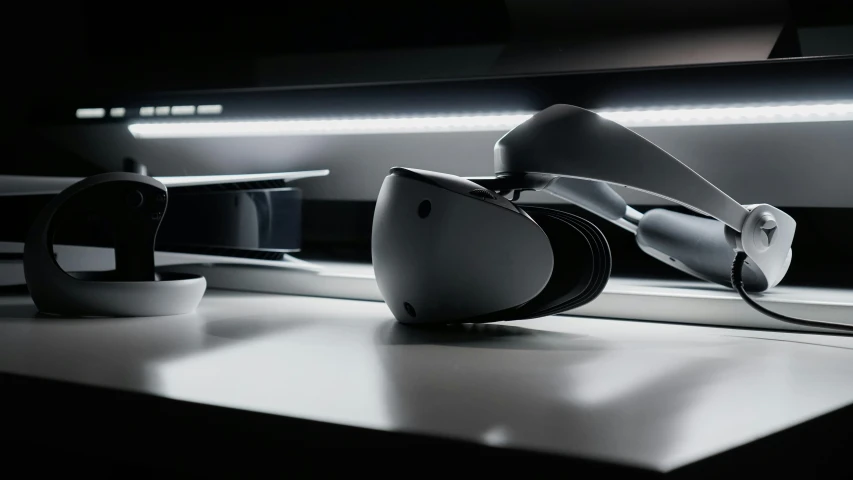a pair of futuristic headsets are shown against a dark background