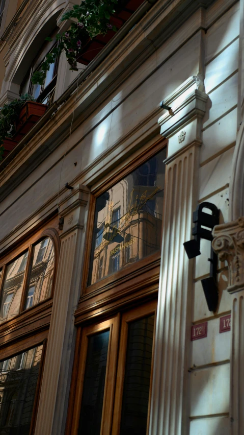 a window and a clock with a statue in it