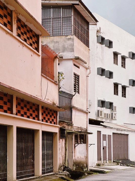 two pink buildings and two doors on the sidewalk