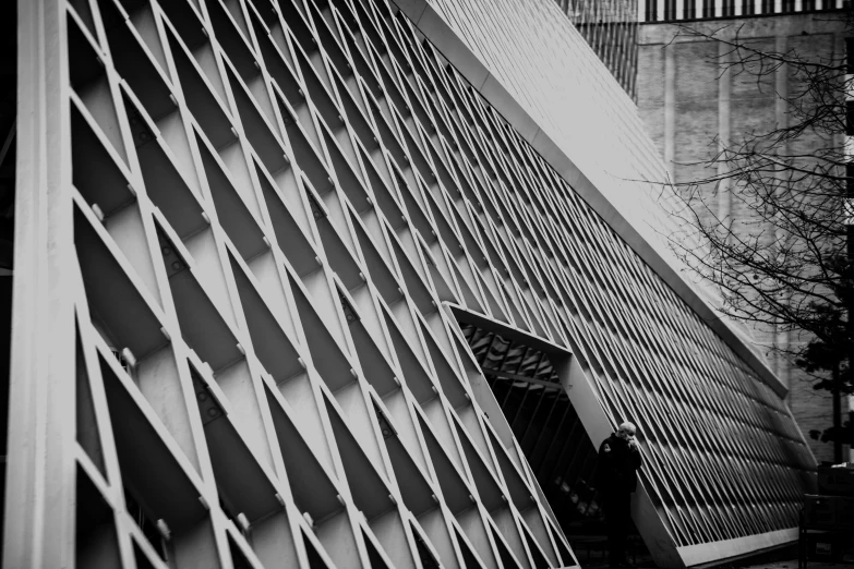 black and white pograph of person walking on the stairs