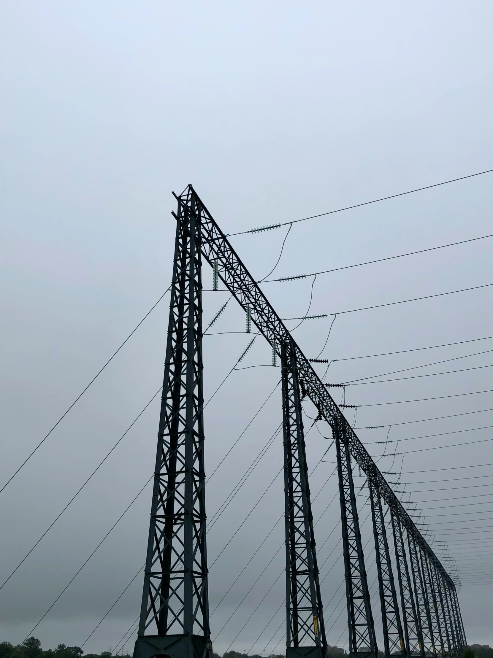 high voltage power line near roadway with telephone poles and wires