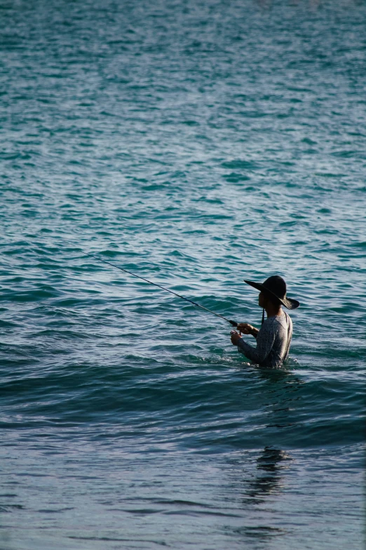 a woman that is sitting on a surfboard in the water