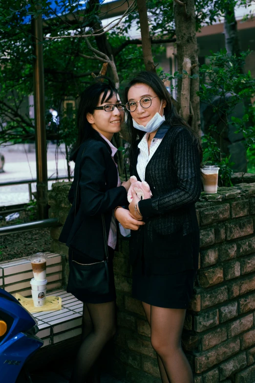 two ladies are posing together at a picnic