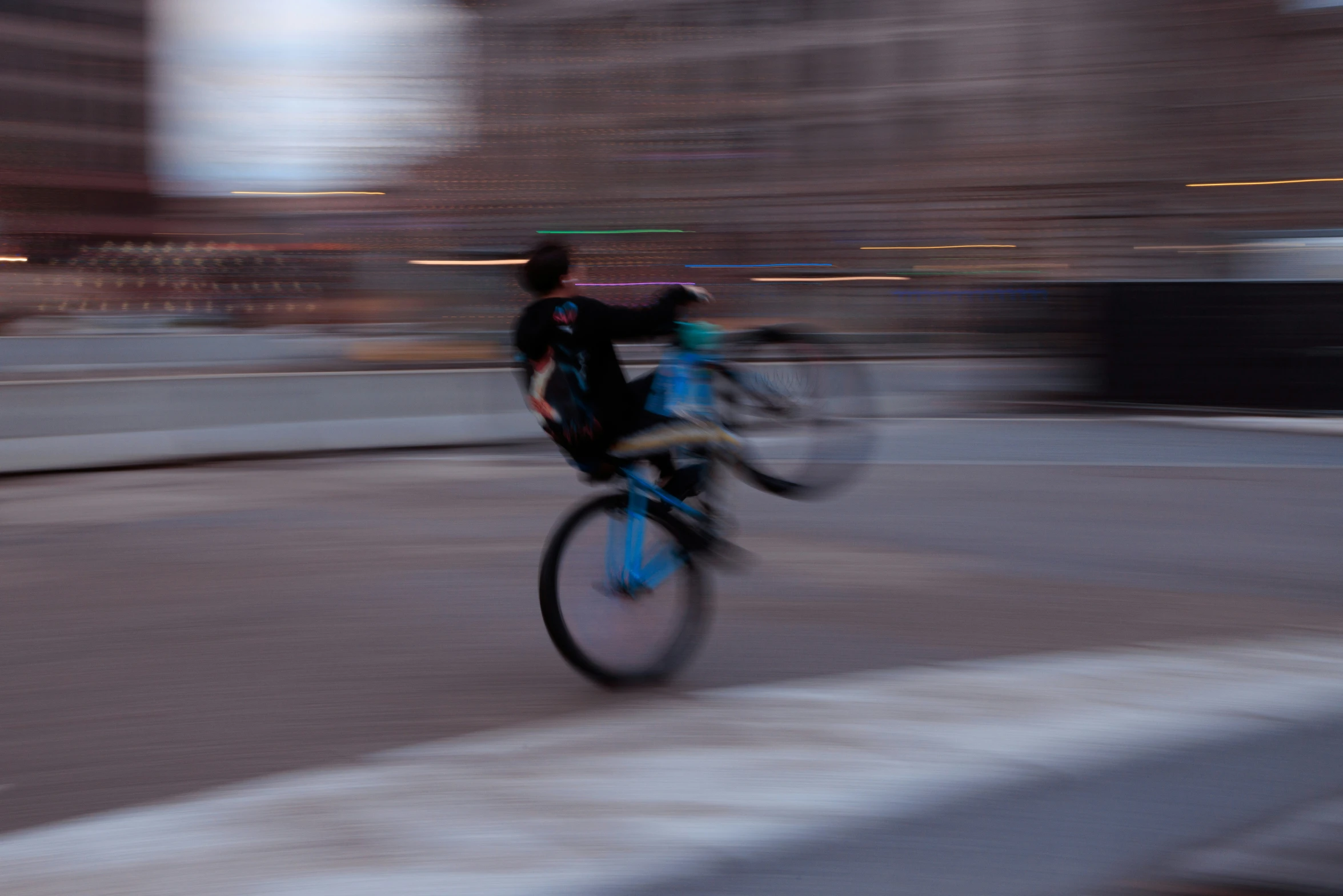 blurry picture of a bicyclist riding down the street