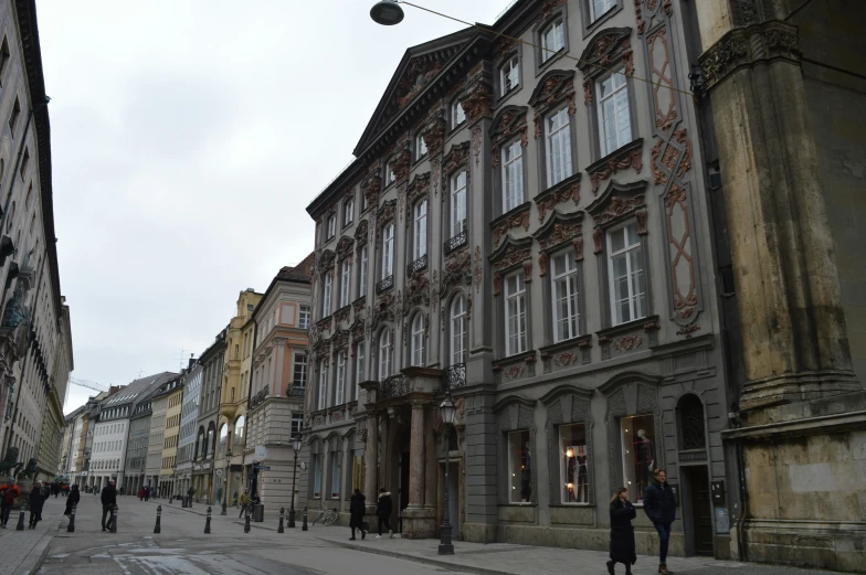 a bunch of people walk down a crowded street