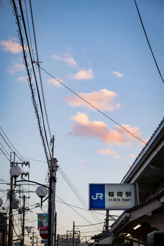 an urban street with telephone wires and a blue sky