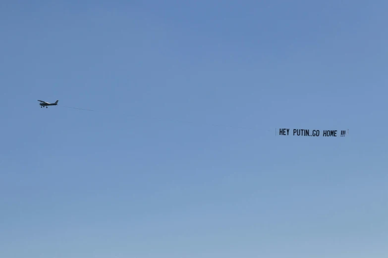 an airplane flies with a sign reading med palolinine