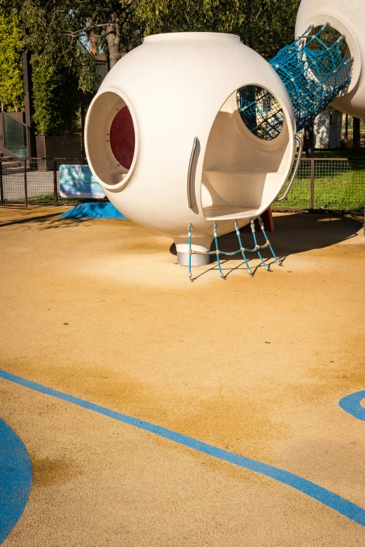 the play area in the park with the tire swing