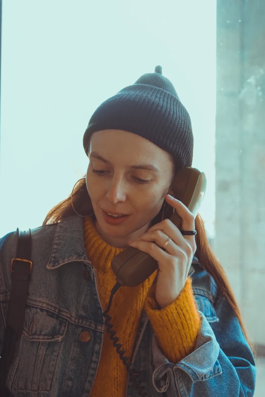 a young woman is talking on the phone outside