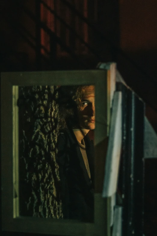 the reflection of a man in the mirror is dark