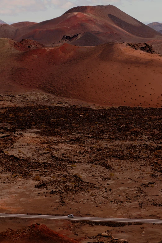 a large mountain sitting in the middle of a desert