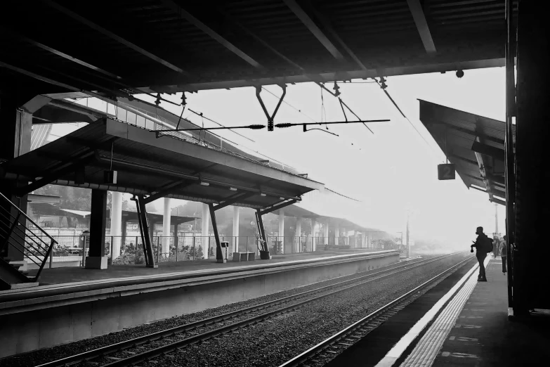 the lone person is walking along the train tracks