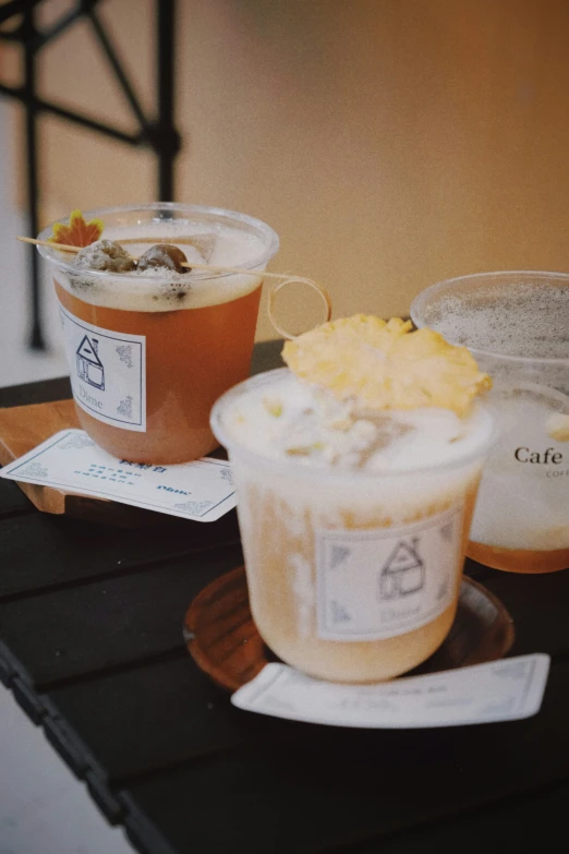 two cups on a table with food and drinks