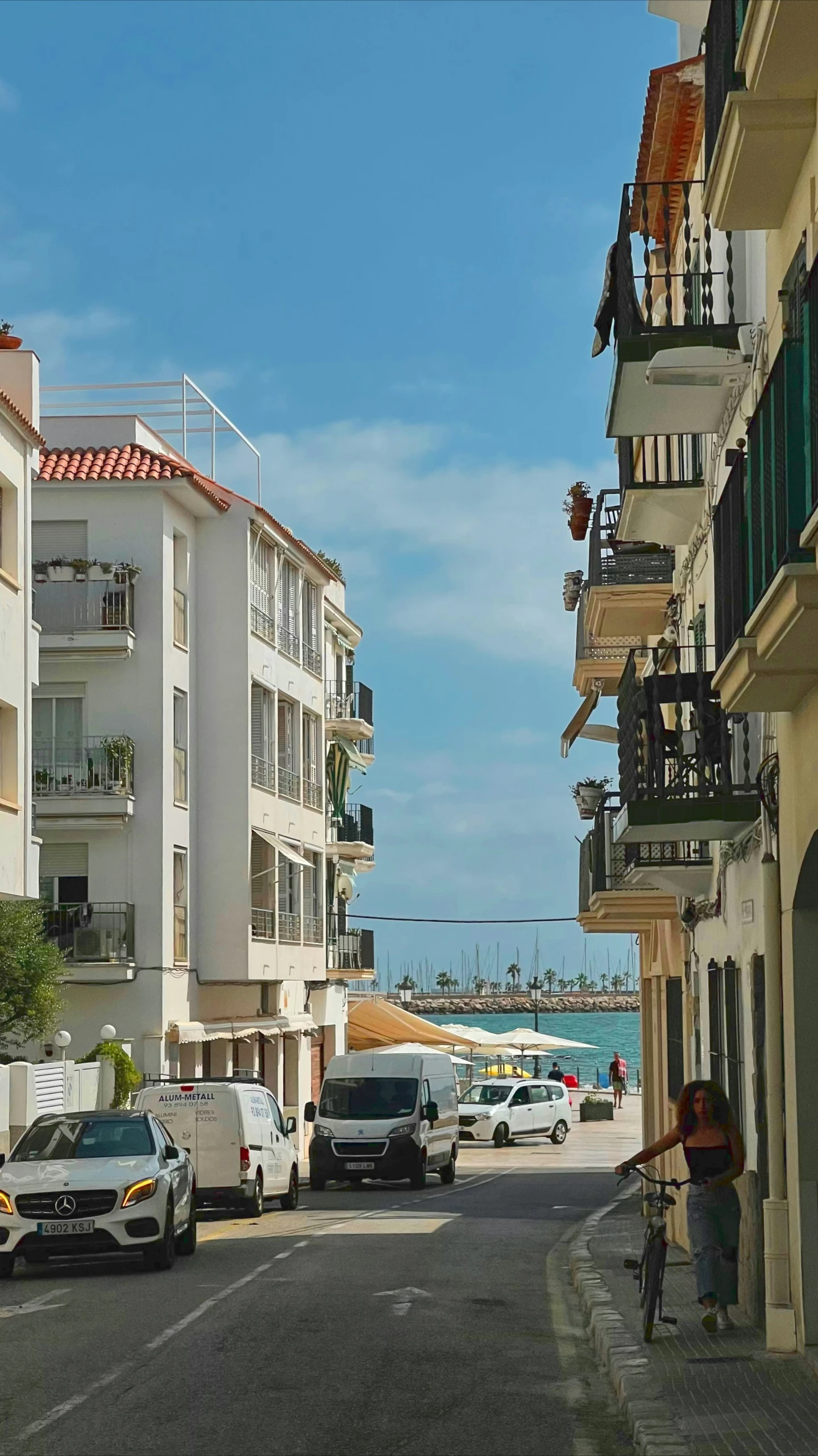 an empty street filled with cars on both sides of it