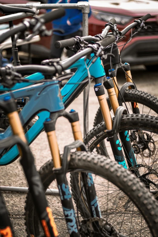 there is a blue bicycle parked in front of two other bikes