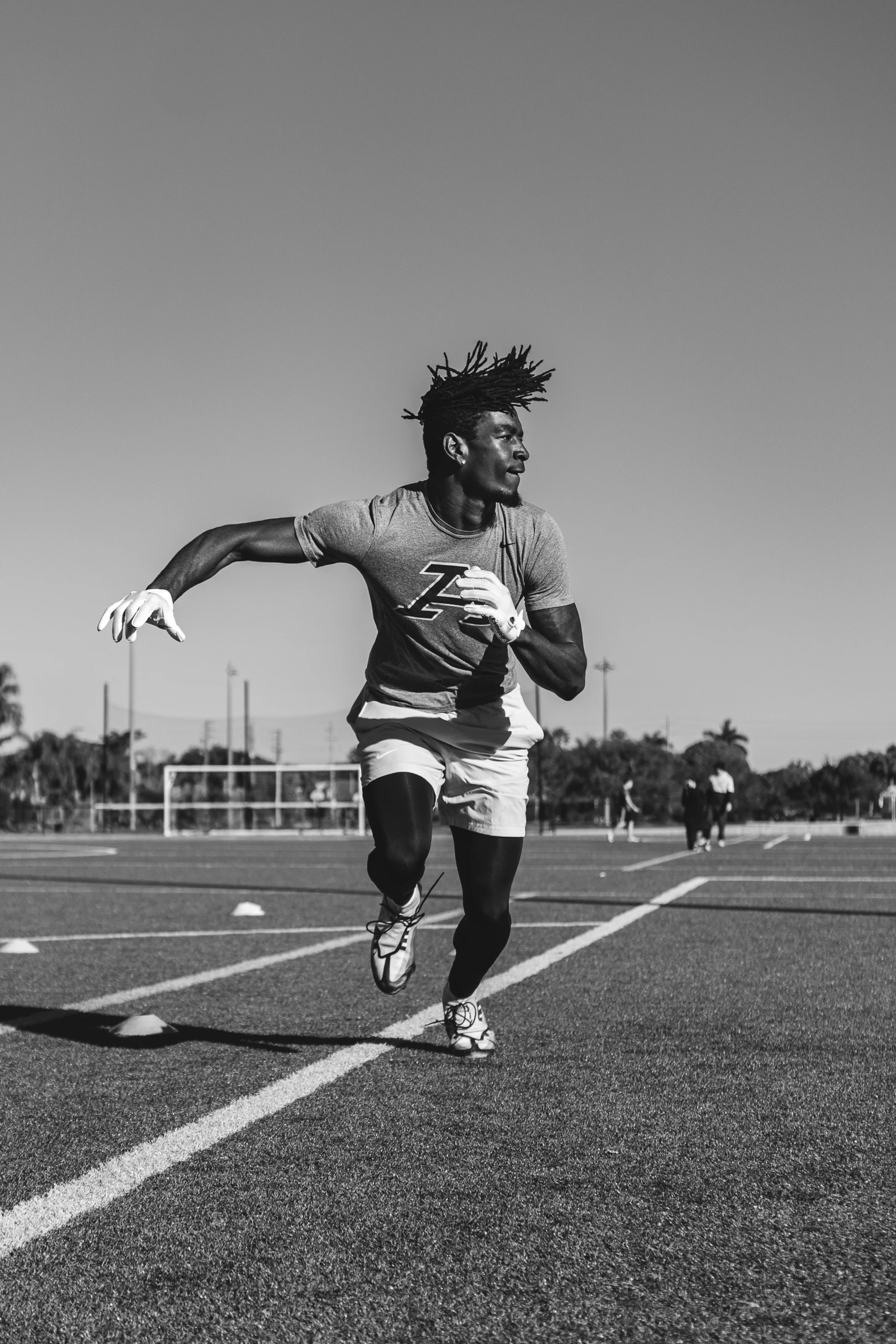 a man that is standing on a field with a frisbee