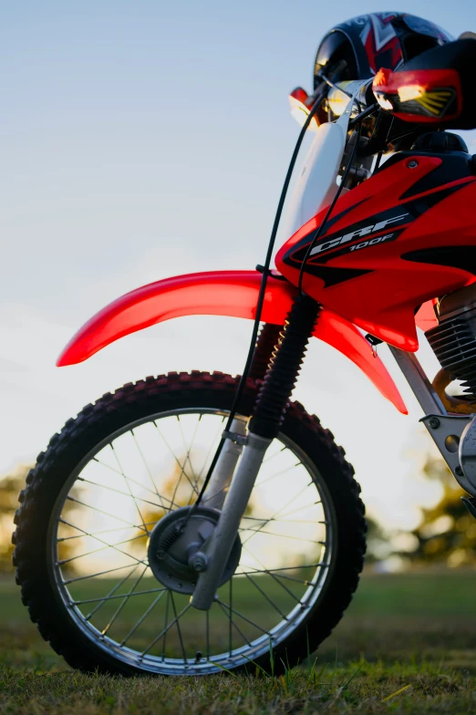 red motorcycle parked on the side of a road