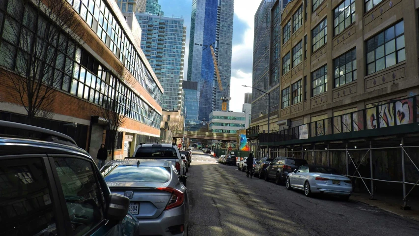 many vehicles and pedestrians drive down the busy street