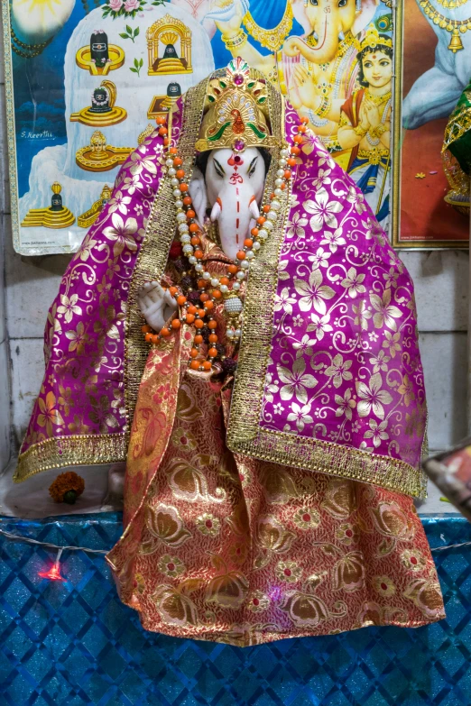 a statue of a man wearing a purple robe