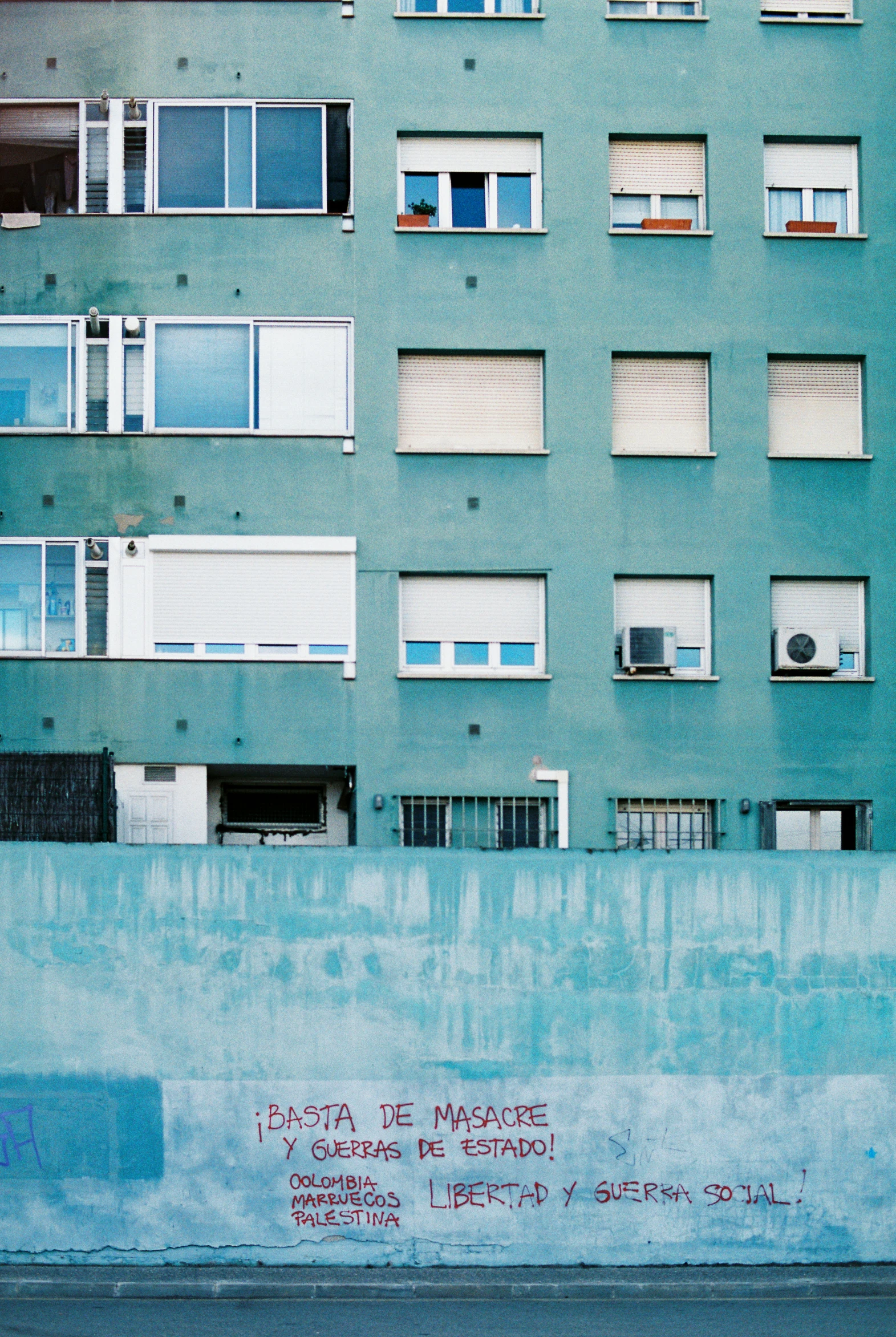 a street scene of an apartment building with graffiti