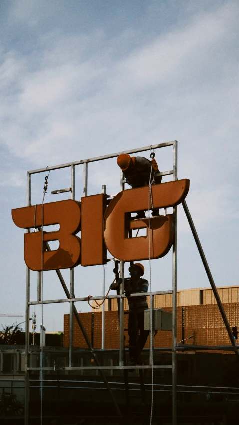 the letters for a building are being lifted