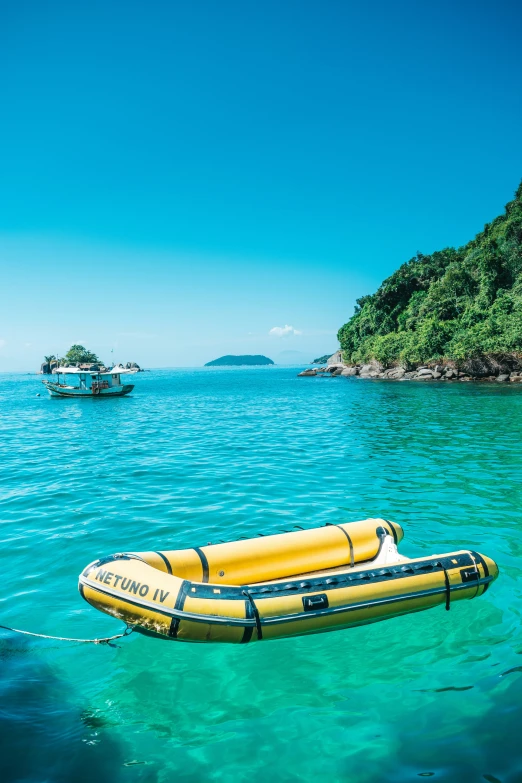 a yellow raft floating across clear blue water