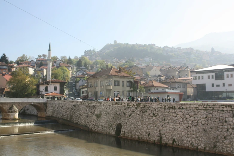 a stone bridge across a river in a village