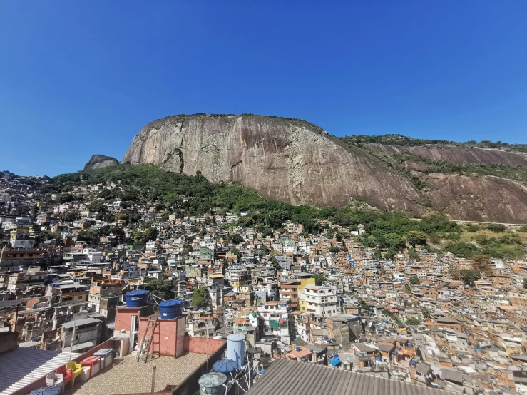 a mountain sits in the background with a village below it