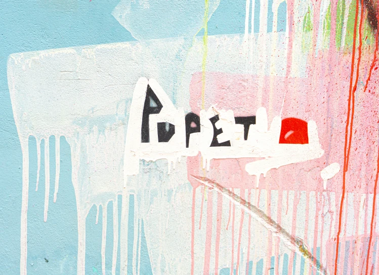 a wall with colorful drips and graffiti writing on it