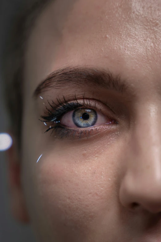 the young woman has blue eyes and brown lashes