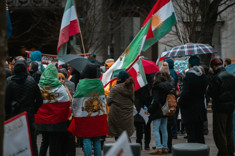 an international rally with many flags holding umbrellas