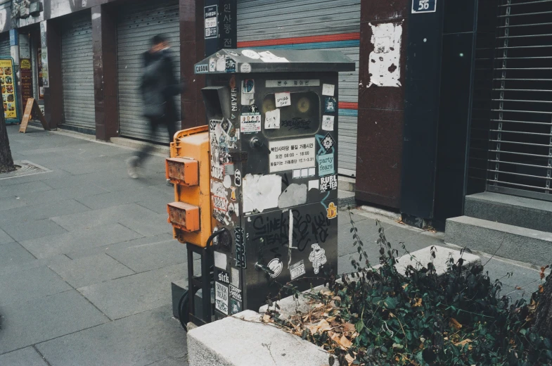 an old looking newspaper dispenser on a city street