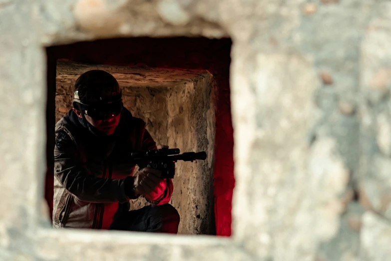 a man in a gas mask aiming his rifle