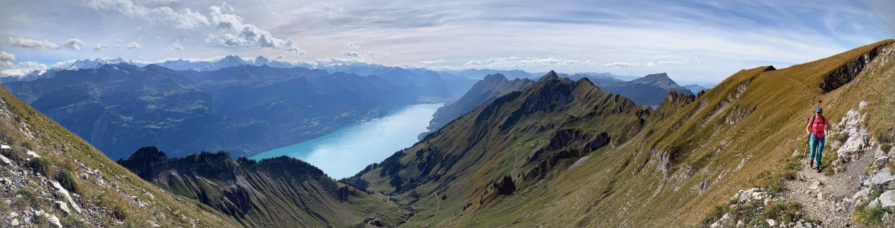 view of mountain ranges from below with blue body of water