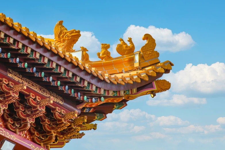 a golden dragon decorates the roof of a building