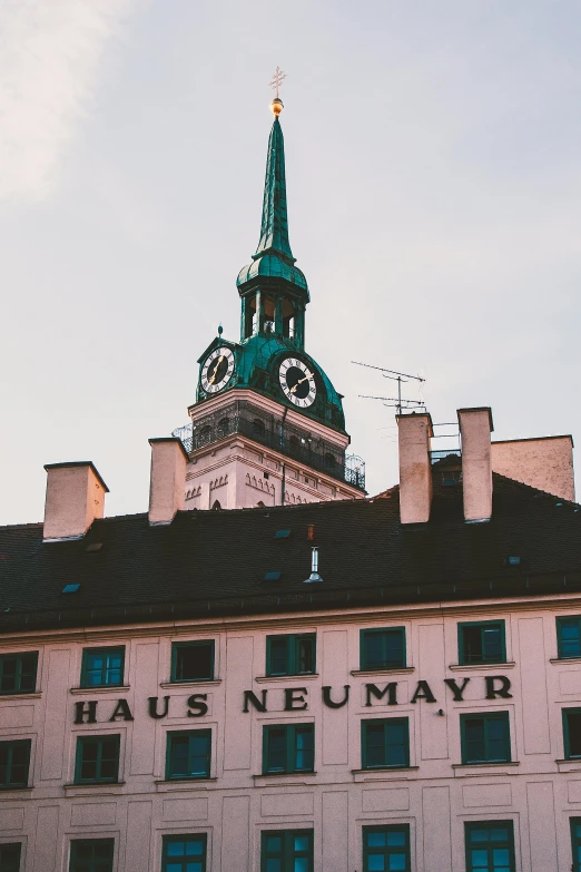 the clock tower is visible behind many windows on the building